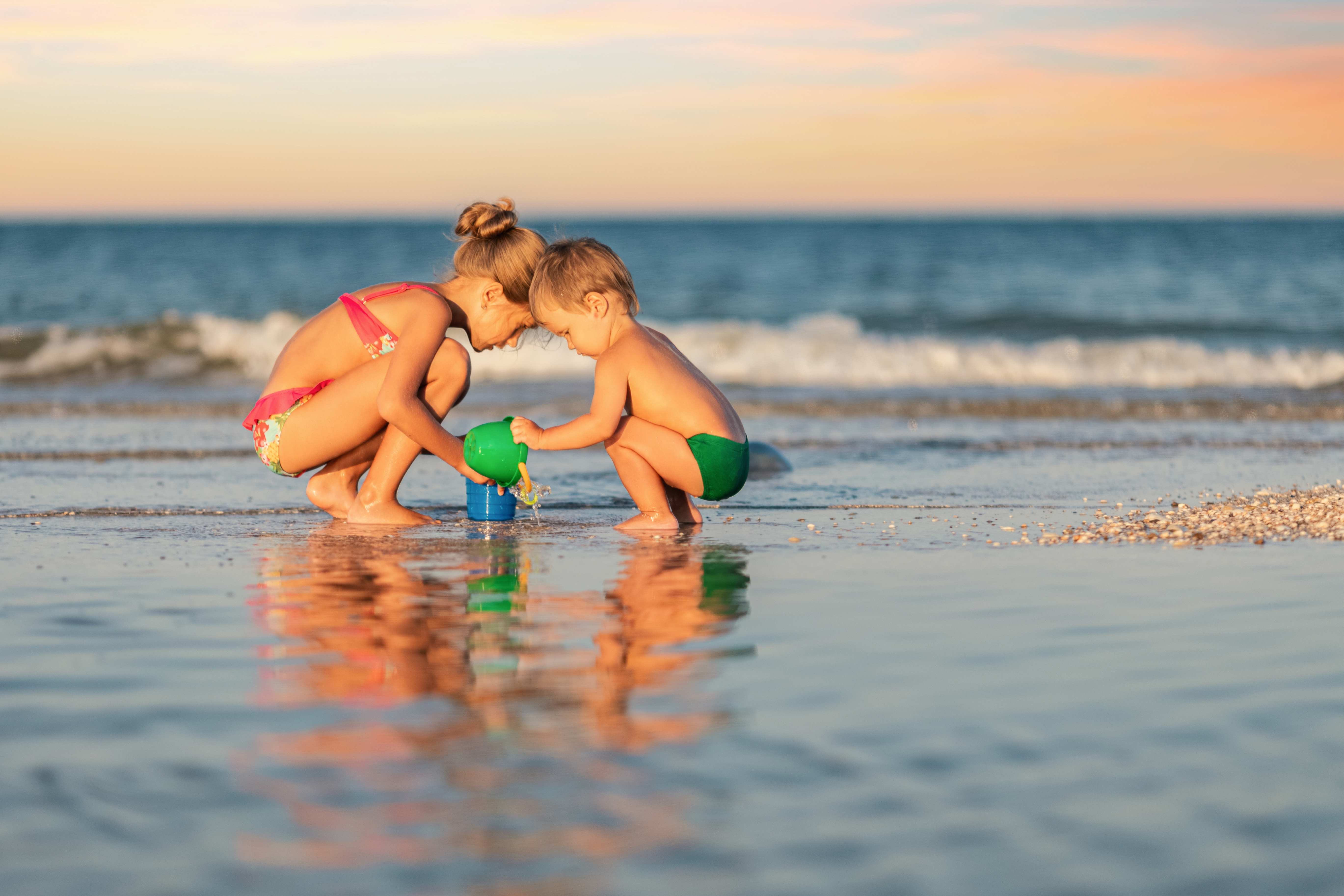 kids playing together on the beach